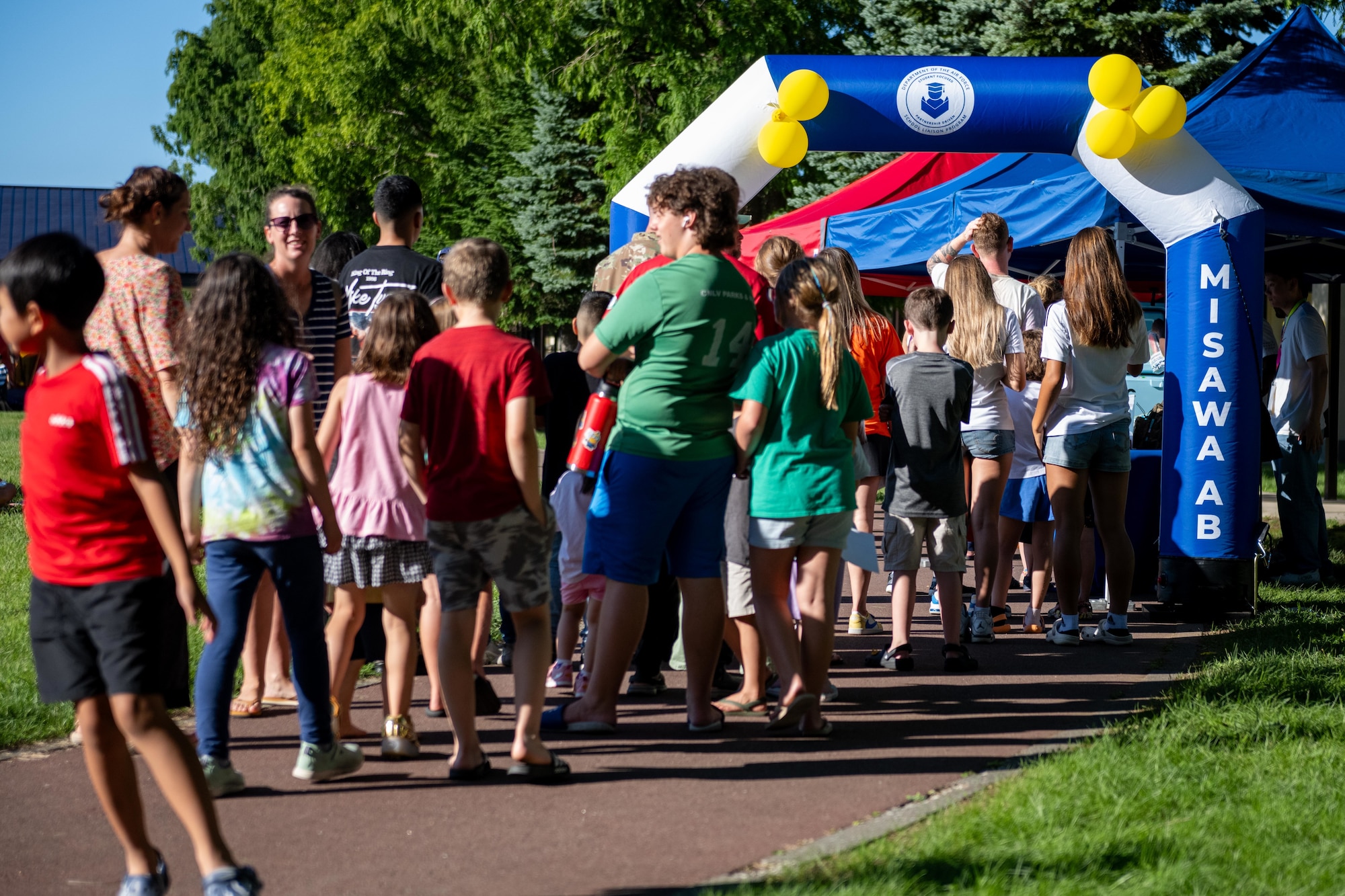 Misawa Air Base (AB) families line up for popsicles and school supplies during a back to school bash event.