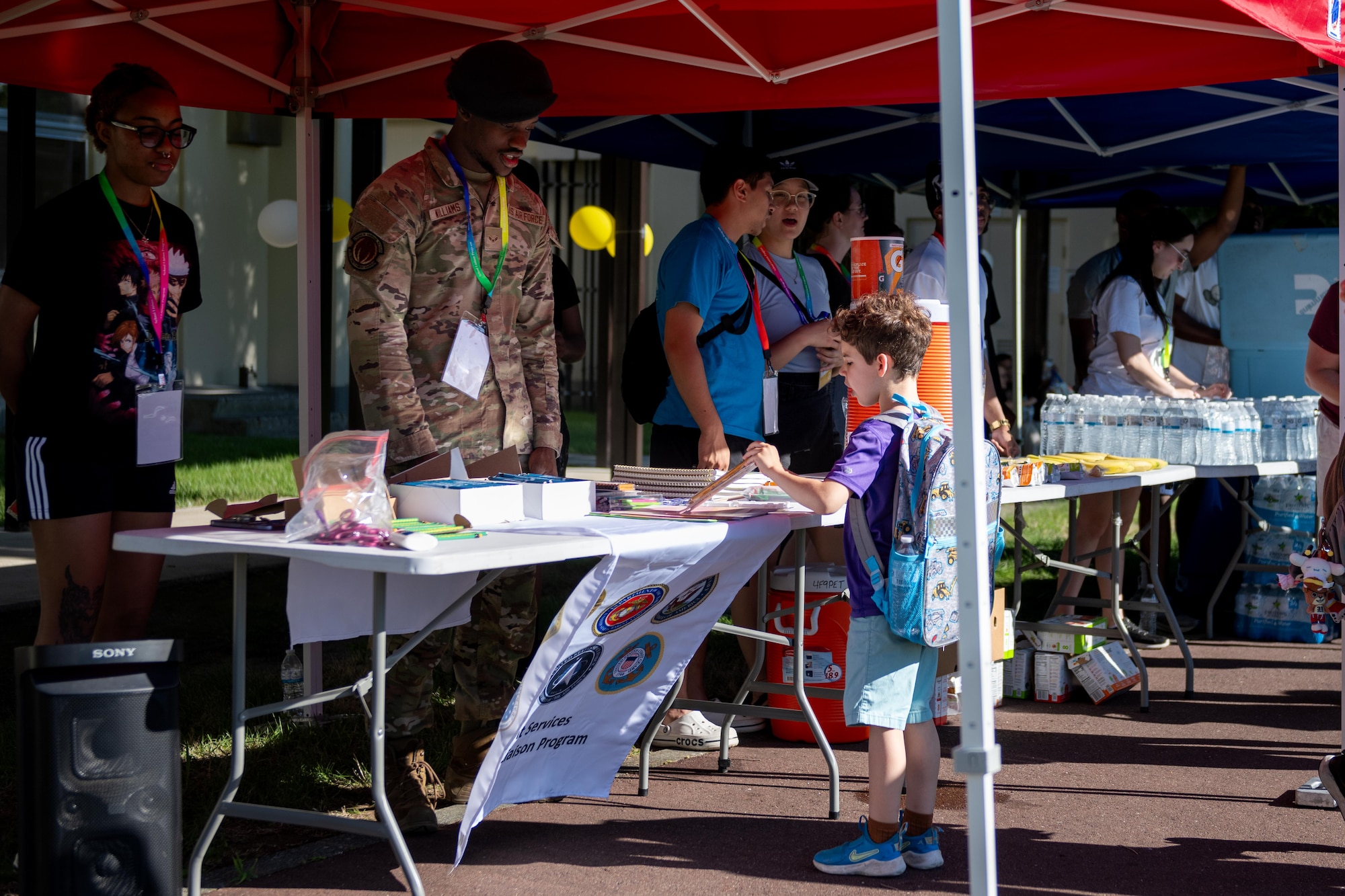 A student picks up school supplies during a back to school bash event.
