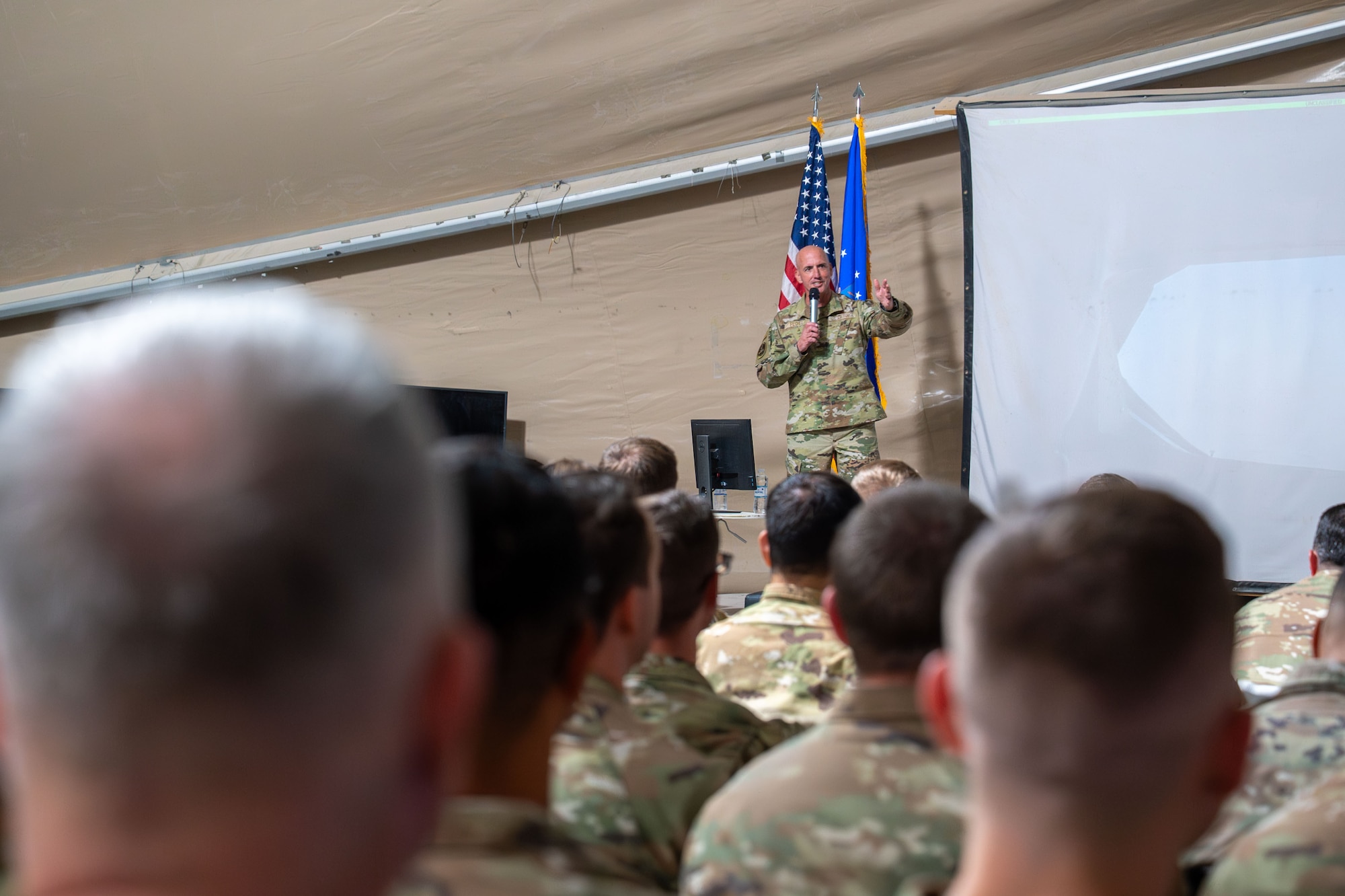 A man talks to a crowd of people.