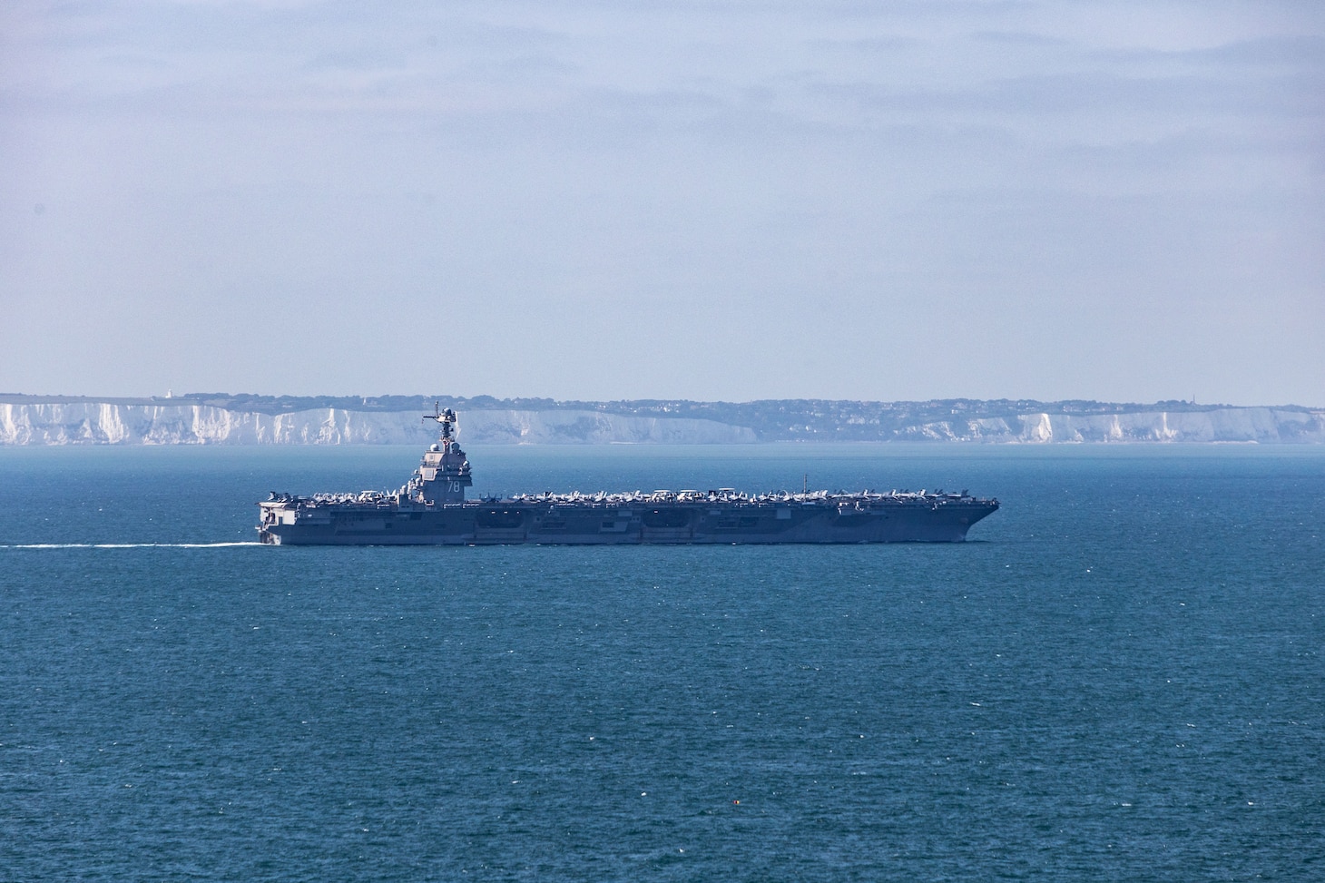 The world's largest aircraft carrier, USS Gerald R. Ford (CVN 78), passes the Cliffs of Dover in the English Channel, Aug. 17, 2025.