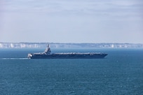 The world's largest aircraft carrier, USS Gerald R. Ford (CVN 78), passes the Cliffs of Dover in the English Channel, Aug. 17, 2025.