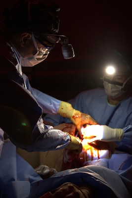 Cmdr. David Ebler (left), general surgeon, and Hospital Corpsman 3rd Class Kevin Greer (right), surgical technologist, Expeditionary Resuscitative Surgical System (ERSS) 20, perform simulated damage control surgery on a high-fidelity manikin during an ERSS training conducted at Naval Expeditionary Medicine Warfighter Development Center (NEMWDC) June 9-17, 2025. Enlisted Sailors play a crucial role in the ERSS team, delivering critical medical care in austere and high‑pressure environments. (U.S. Navy photo by Petty Officer 2nd Class Moira Esquivel)