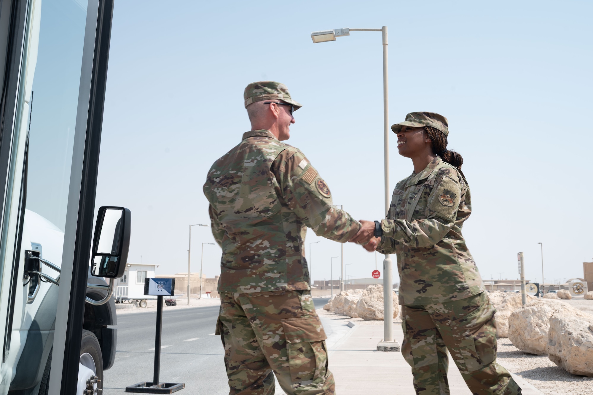 Chief Master Sgt. of the Air Force David Flosi shakes hands with Chief Master Sgt. Carolyn A. Russell, 379th Air Expeditionary Wing command chief, during a visit within the U.S. Central Command area of responsibility, Aug. 12, 2025. The visit gave CMSAF the opportunity to engage directly with Airmen and soldiers across CENTCOM AOR, address their concerns, and recognize their contributions to regional security. (U.S. Air Force photo by Dieondiere Jefferies)