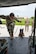 A U.S. Air Force military working dog handler and his dog board a helicopter.