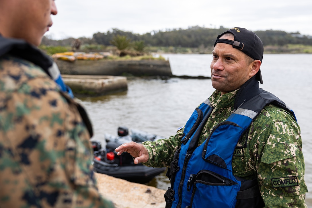 Sub Oficial de Segunda John Gonzalez, jefe del peloton de embarcaciones explains the grading process to U.S. Marine Corps Sgt. Ronald Arce, an infantry rifleman with U.S. Marine Corps Forces, South, during a subject matter expert exchange in Uruguay, August 14, 2025. This subject matter expert exchange enhances the training and readiness standards for the United States and Uruguay as well as facilitating the exchange of formalized readiness standards between both countries. Arce is a native of Texas. (U.S. Marine Corps photo by Sgt. Eduardo Delatorre)