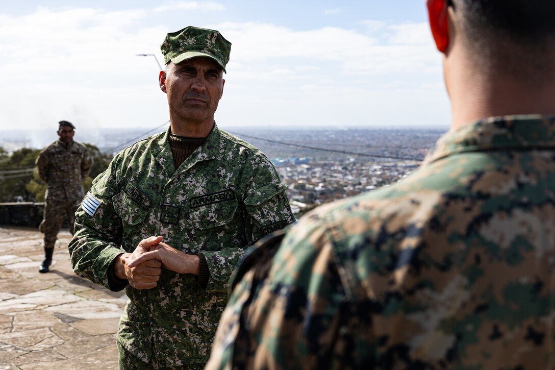 Sub Oficial de Comando Mario Marcel de la infanteria de marina de Uruguay, explains the importance of a historic site to U.S. Marine Corps Sgt. Ronald Arce, an infantry rifleman with U.S. Marine Corps Forces, South, during a subject matter expert exchange in Uruguay, August 14, 2025. This subject matter expert exchange enhances the training and readiness standards for the United States and Uruguay as well as facilitating the exchange of formalized readiness standards between both countries. Arce is a native of Texas. (U.S. Marine Corps photo by Sgt. Eduardo Delatorre)