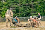 A team of Tactical Combat Casualty Care (TCCC) students conducts medical training during an exercise Aug. 14, 2025, at the Bangor Air National Guard Base, Bangor, ME. TCCC is a comprehensive training program developed by the Department of Defense to teach service members life-saving techniques for battlefield trauma care.