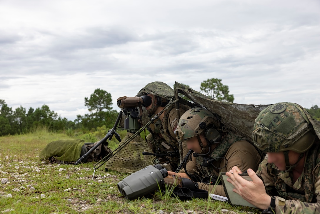 Dutch Marines with 25 RSTA Squadron, utilize a Joint Fires Support System, multifunctional binoculars, and an Android Tactical Assault Kit to conduct close air support during exercise Burmese Chase 25 at Marine Corps Base Camp Lejeune, North Carolina, Aug. 12, 2025. Burmese Chase is an annual U.S. led, multi-lateral training exercise comprised of integrating ground and air fires, infantry tactics and naval gunfire alongside NATO allies to enhance combat readiness and interoperability. (U.S. Marine Corps photo by LCpl. Payton Walley) (This photo has been altered for security purposes by blurring out faces.)