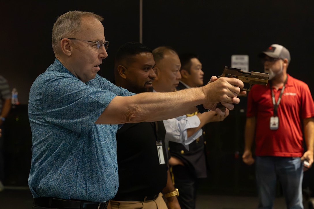 Retired U.S. Marine Corps Lt. Gen. Wallace “Chip” Gregson, distinguished senior fellow (non-resident), Sasakawa Peace Foundation USA, dry fires a training M18 pistol at the Indoor Simulated Marksmanship Trainer on Marine Corps Base Camp Lejeune, Aug. 6, 2025. The Japan U.S. Military Program connects U.S. service members, families and civilians who have served in Japan through a partnership between Sasakawa Peace Foundation USA, the Embassy of Japan and the National Association of Japan-America Societies. (U.S. Marine Corps photo by Lance Cpl. Erica S. Padgett)