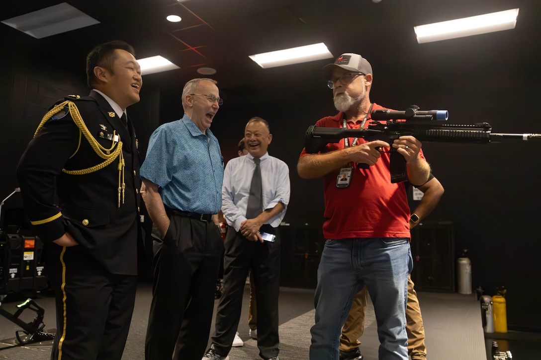 Michal Beech, an Indoor Simulated Marksmanship Trainer (ISMT) instructor, demonstrates dry fire training aids at the ISMT at Marine Corps Base Camp Lejeune, Aug. 6, 2025. The Japan U.S. Military Program connects U.S. service members, families and civilians who have served in Japan through a partnership between Sasakawa Peace Foundation USA, the Embassy of Japan and the National Association of Japan-America Societies. (U.S. Marine Corps photo by Lance Cpl. Erica S. Padgett)