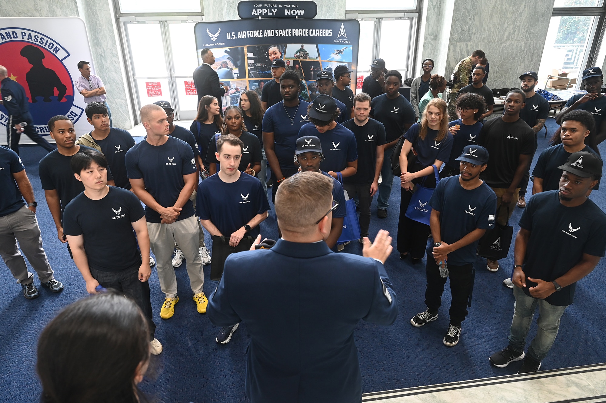 Air Force Master Sergeant Edwin Spoor (foreground) directs members of the Delayed Entry Program at the Rayburn Office Building, Washington, D.C. Aug 15, 2025.