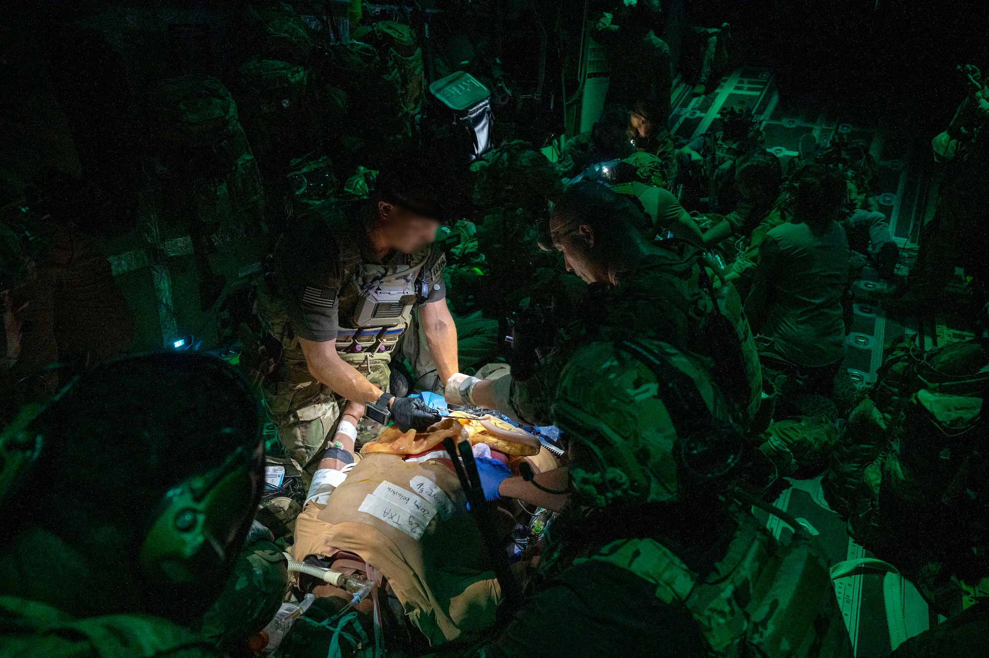 AFSOC Airmen provide medical care to a simulated patient on a MC-130J Commando II during Emerald Warrior 25.2.
