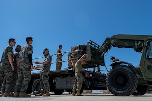 Members of the Republic of Korea Marine Corps watch as U.S. Marine Corps airborne delivery specialists and U.S. Air Force loadmasters assigned to the 16th Airlift Squadron load cargo during a routine training mission at Kunsan Air Base, South Korea, July 21, 2025. Air Mobility Command aircraft enable local, routine training and operations to deliver rapid global mobility, ensuring U.S. and Allied forces can project power and respond swiftly anywhere in the world. With a fleet of versatile aircraft, AMC provides the critical capability to transport personnel, equipment, and supplies when and where needed. (U.S. Air Force photo by Senior Airman Zachary Foster)