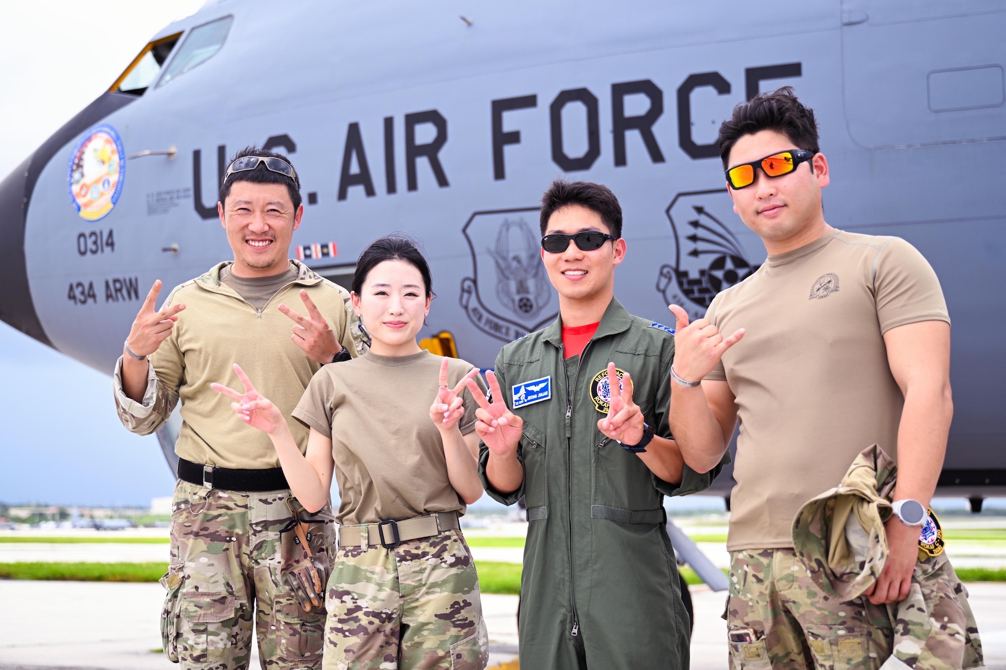Republic of Korea Air Force members pose with U.S. Air Force 1st Lt. Esther Kim, Space Systems Command director of contracting and Language Enabled Airman Program participant, Los Angeles Air Force Base, California, during the U.S. Air Force’s 2025 Department-Level Exercise series at Andersen Air Force Base, Guam, July 28, 2025. LEAP empowers the DLE by enhancing linguistic and cultural interoperability, enabling more effective collaboration and mission success with partners and allies. DLE 2025 is a new way of conducting operations in a contested, dynamic environment to build capabilities, making a stronger, more deterrent force. The DLE encompasses all branches of the Department of Defense, along with Allies and partners, employing more than 400 Joint and coalition aircraft and more than 12,000 members at more than 50 locations across 3,000 miles. (Courtesy photo by ROKAF)
