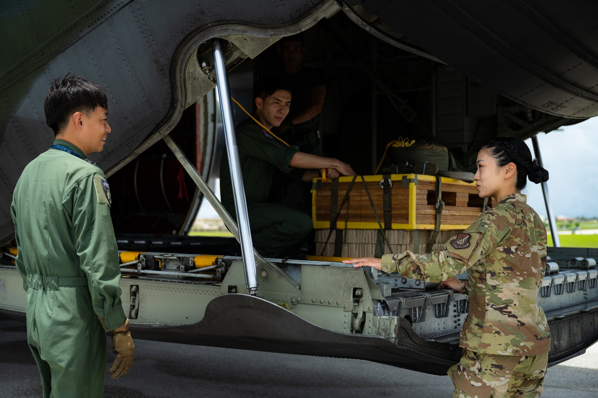 From left, Japan Air Self-Defense Force service members talk with U.S. Air Force 2nd Lt. Julie Tatemoto, 51st Operations Support Squadron airfield operations director of operations and Language Enabled Airman Program participant, Osan Air Base, South Korea, during the U.S. Air Force’s 2025 Department-Level Exercise series at Andersen Air Force Base, Guam, July 22, 2025. LEAP empowers the DLE by enhancing linguistic and cultural interoperability, enabling more effective collaboration and mission success with partners and allies. DLE 2025 is a new way of conducting operations in a contested, dynamic environment to build capabilities, making a stronger, more lethal deterrent force. The DLE encompasses all branches of the Department of Defense, along with Allies and partners, employing more than 400 Joint and coalition aircraft and more than 12,000 members at more than 50 locations across 3,000 miles. (U.S. Air Force photo by Senior Airman Jade M. Caldwell)