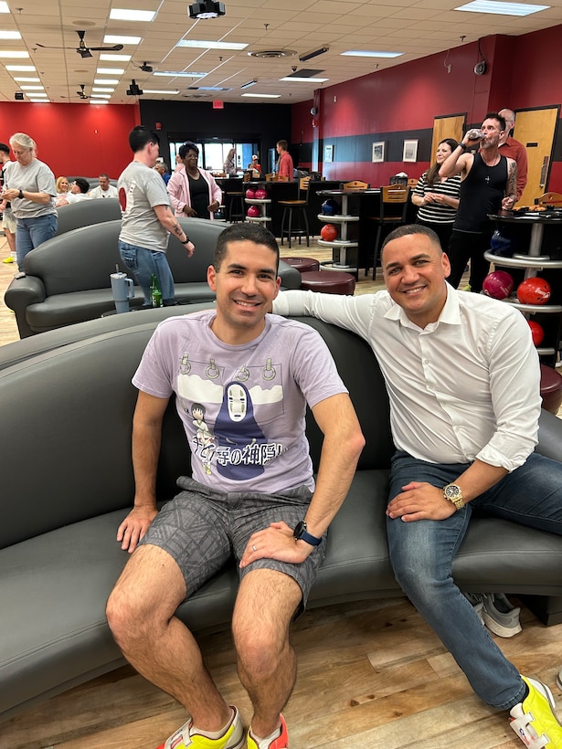 Two men sit on a sofa