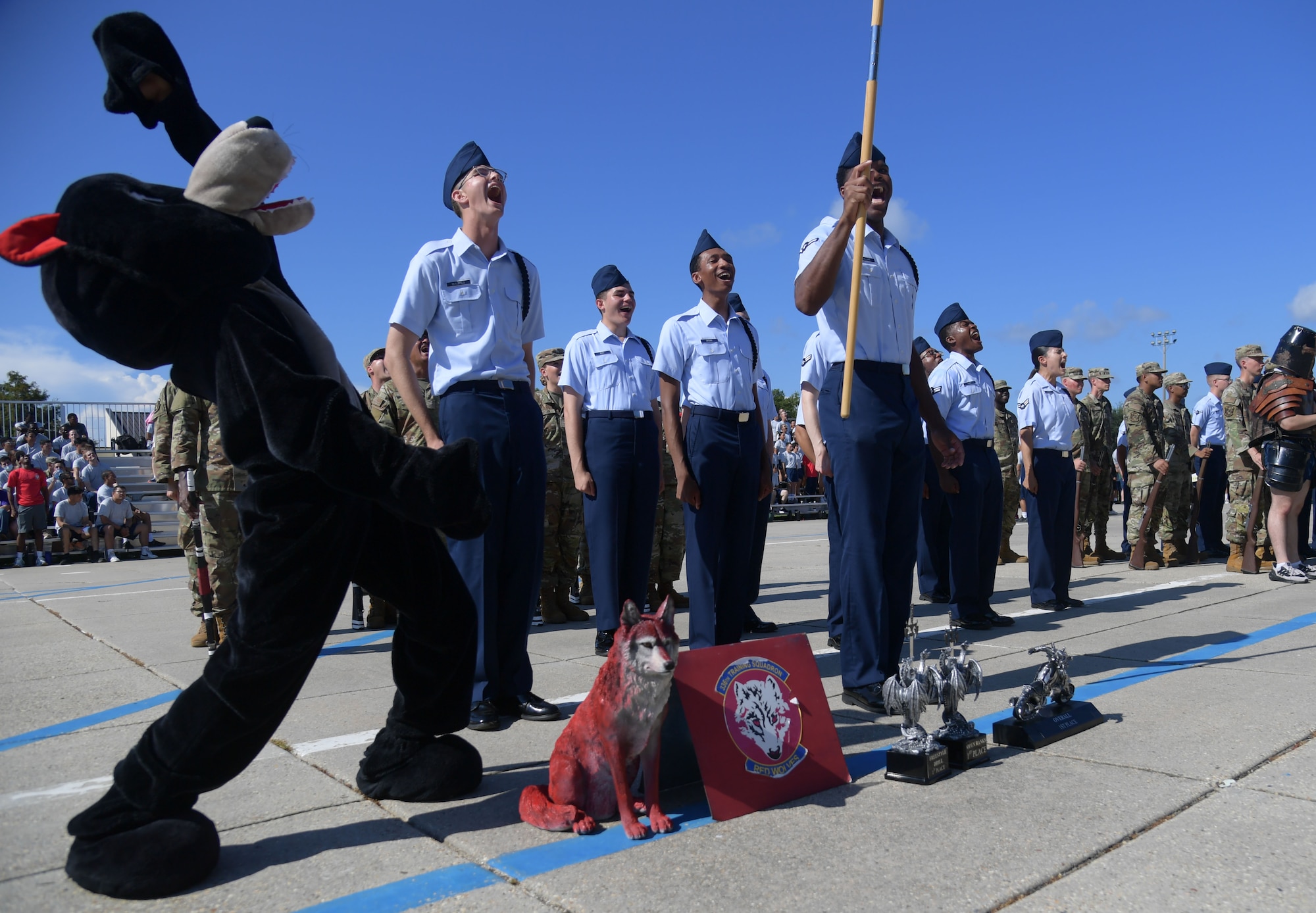 People in military uniform cheer and yell