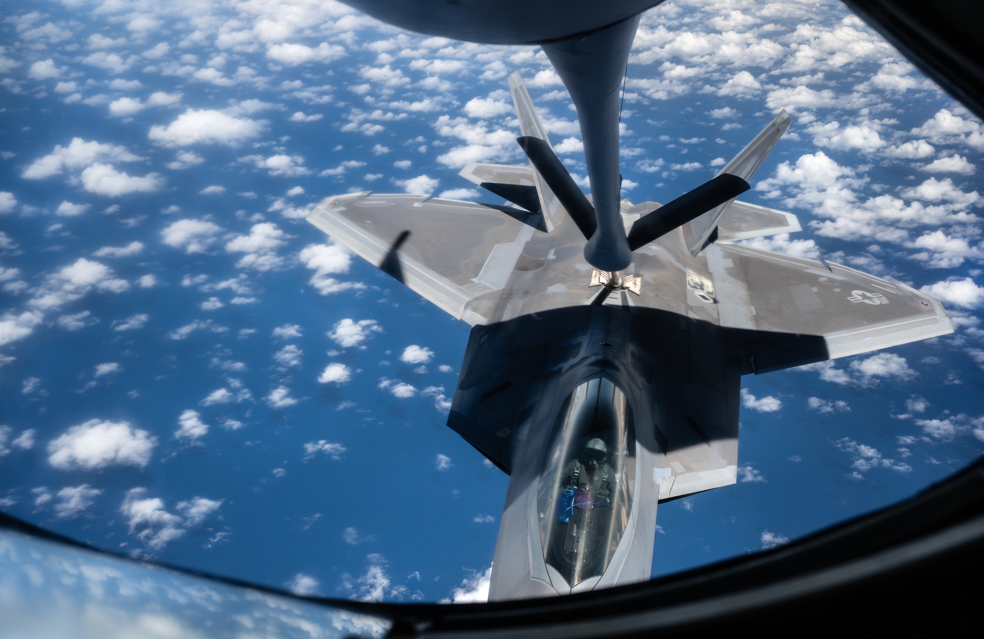 An F-22 Raptor aircraft assigned to the 90th Fighter Squadron receives fuel from a KC-135 Stratotanker aircraft operated by an aircrew assigned to the 350th Air Refueling Squadron, during the U.S. Air Force’s 2025 Department-Level Exercise series at Andersen Air Force Base, Guam, July 20, 2025. The 350th ARS operates the KC-135, conducting air refueling missions necessary to support air mobility on a global scale. The DLE series encompasses all branches of the Department of Defense, along with allies and partners, employing more than 400 joint and coalition aircraft and more than 12,000 personnel across more than 50 locations across 3,000 miles. (U.S. Air Force photo by Staff Sgt. Tryphena Mayhugh)