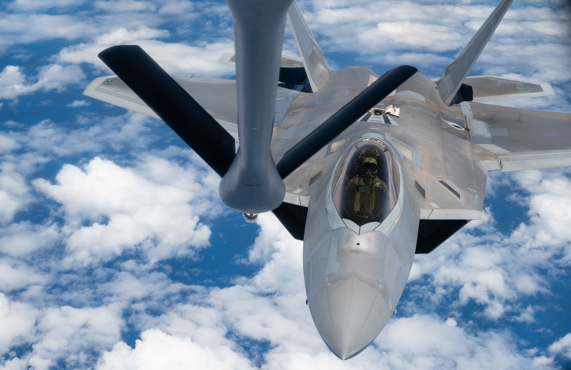 An F-22 Raptor aircraft assigned to the 90th Fighter Squadron approaches the boom of a KC-135 Stratotanker aircraft operated by an aircrew assigned to the 350th Air Refueling Squadron, during the U.S. Air Force’s 2025 Department-Level Exercise series at Andersen Air Force Base, Guam, July 20, 2025. The 350th ARS operates the KC-135, conducting air refueling missions necessary to support air mobility on a global scale. The DLE series encompasses all branches of the Department of Defense, along with allies and partners, employing more than 400 joint and coalition aircraft and more than 12,000 personnel across more than 50 locations across 3,000 miles. (U.S. Air Force photo by Staff Sgt. Tryphena Mayhugh)