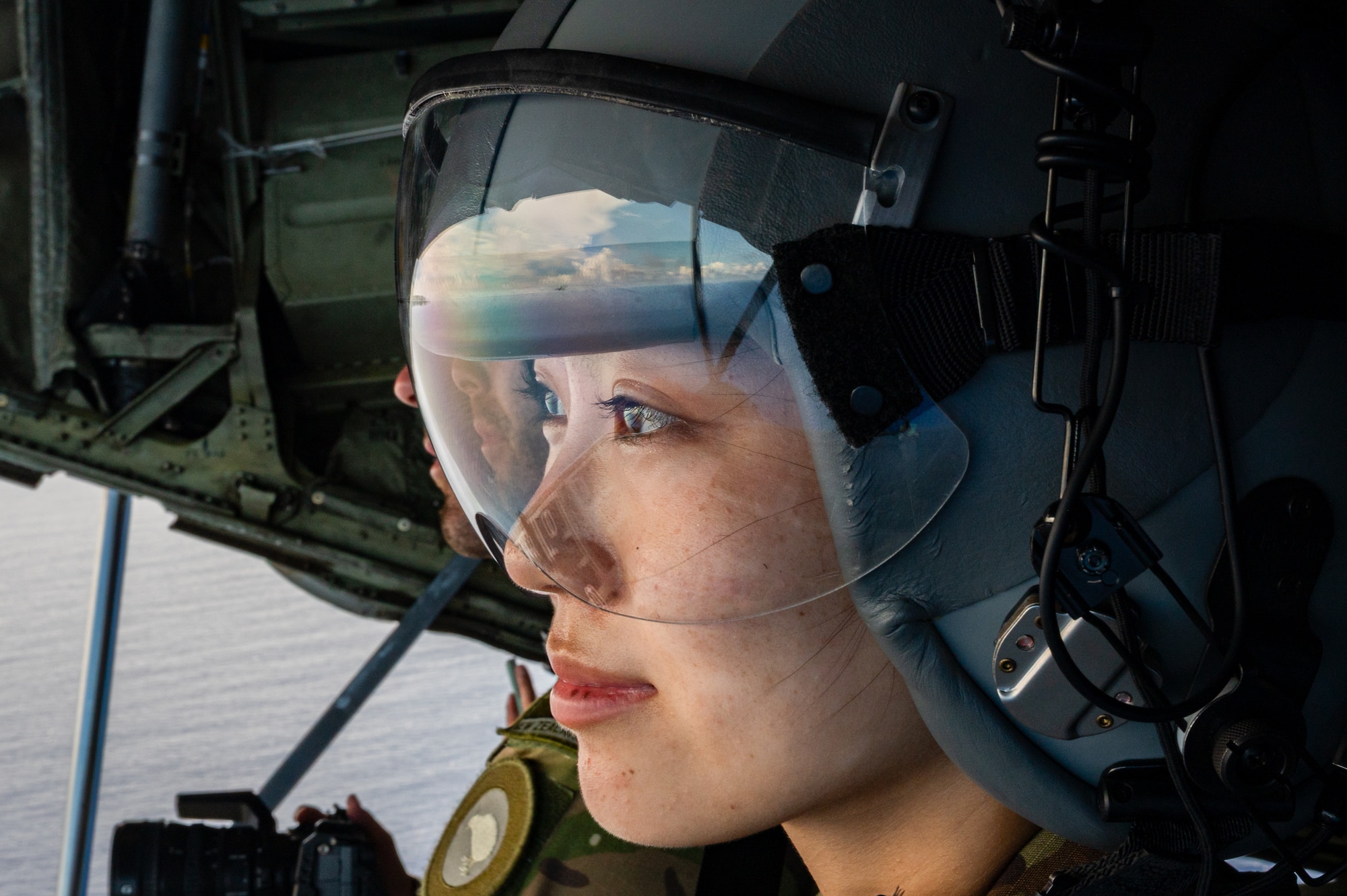 U.S. Air Force 2nd Lt. Julie Tatemoto, an airfield operations officer assigned to the 51st Operations Support Squadron, Osan Air Base, South Korea, looks off the ramp of a C-130J Super Hercules supporting a flyover for the 81st Liberation Day Parade in Hagåtña, Guam, July 21, 2025, leveraging a training sortie during the Department-Level Exercise series at Andersen Air Force Base, Guam. The flights consisted of 13 waves of aircraft from the U.S. Air Force, Royal New Zealand Air Force, Japan Air Self-Defense Force, Republic of Korea Air Force, and the Royal Australian Air Force showcasing the U.S. and its allies' commitment to a free and open Indo-Pacific. (U.S. Air Force photo by Staff Sgt. Tyler McQuiston)