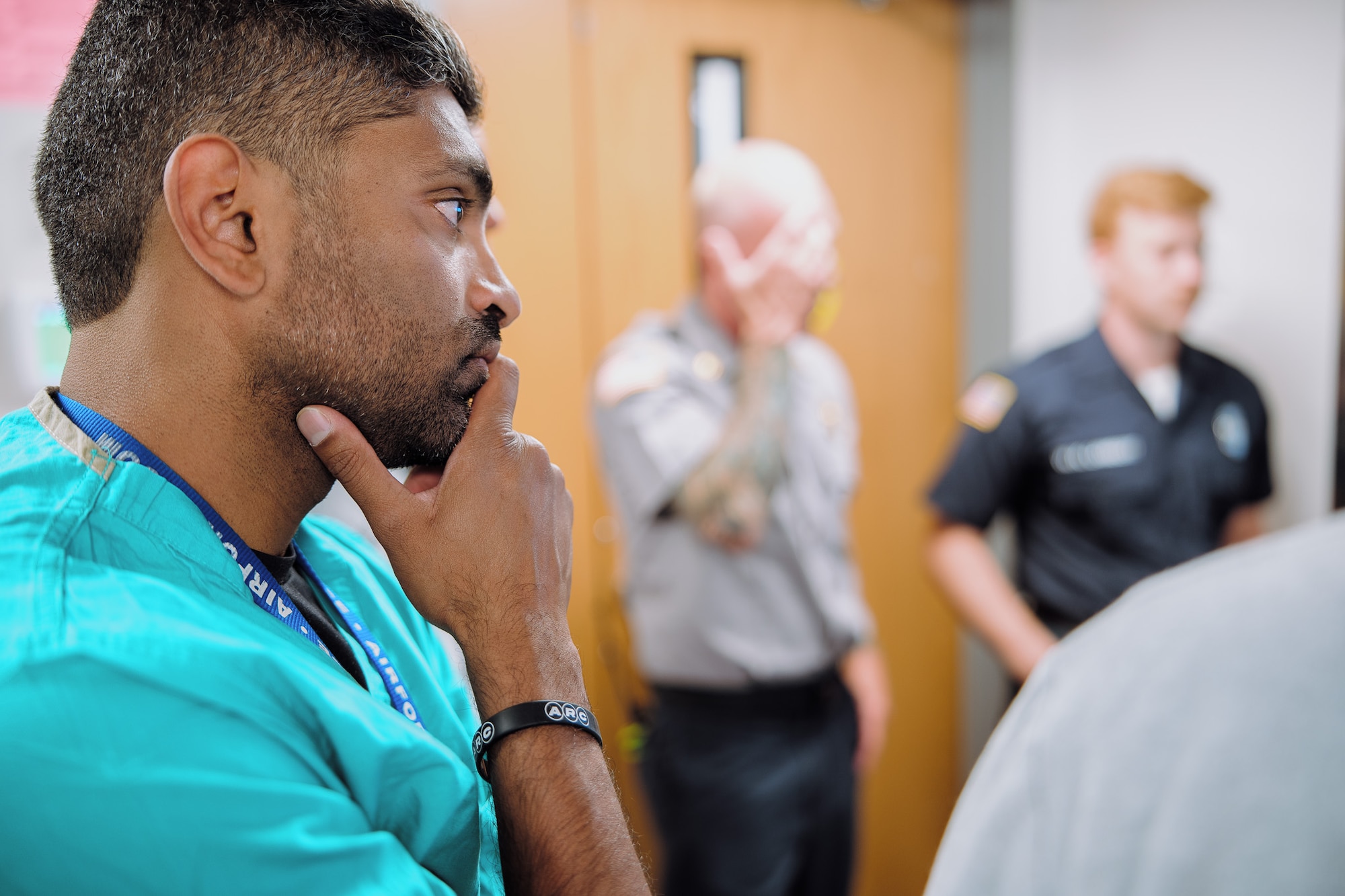 Lt. Col. Reynold Henry, 55th Medical Group trauma surgeon embedded with the University of Nebraska Medical Center in Omaha, Nebraska, listens in as he and emergency medical crews are briefed about the prehospital whole blood transfusion program at a hospital in Omaha, Nebraska, June 30, 2025. Henry advocated for the program based on his medical military combat experience. (Courtesy photo)
