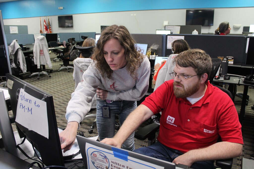 (Right) Ashley Foster, an Emergency Management Specialist with the Jacksonville District, talks with deployment members
Emergency Field Office during Hurricane Milton in Sarasota, Fla. Foster was recently named the 2024 USACE Emergency
Management Specialist of the Year.(USACE photo by Mark Rankin)
