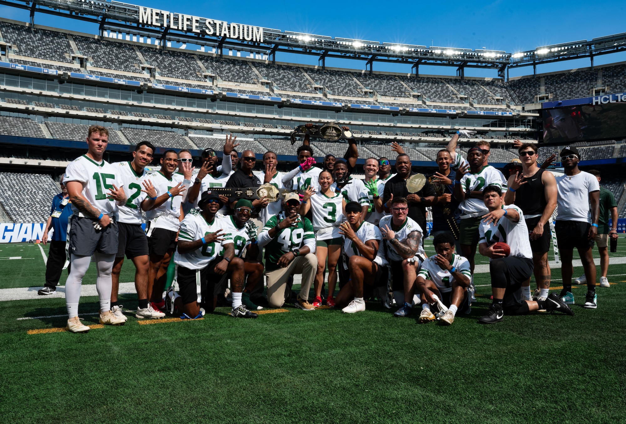 Service members from Joint Base McGuire-Dix-Lakehurst, N.J., pose with their newly won Salute to Service Bowl belt at MetLife Stadium, N.J., Aug. 16, 2025. The game is organized each year by the New York Jets and the New York Giants to honor service members from each of the armed forces.
