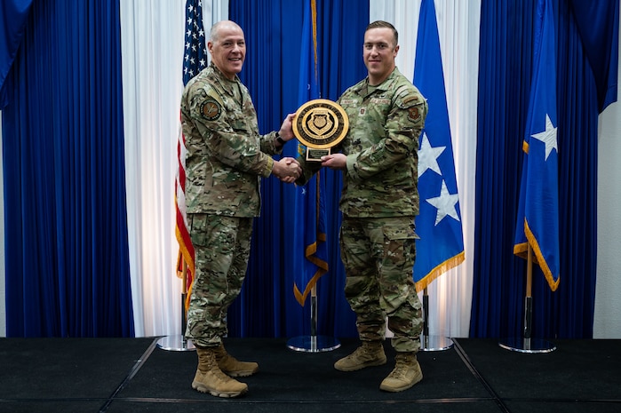 Airman at a ceremony posing for a photo.