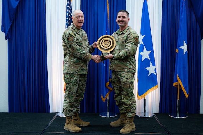 Airman at a ceremony posing for a photo.