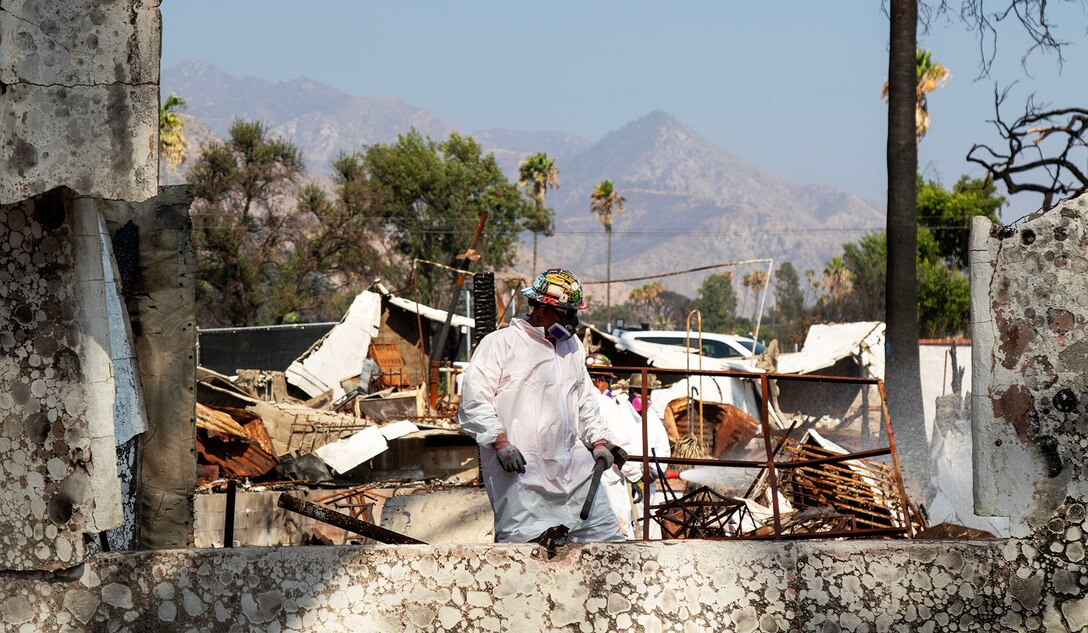 A U.S. Army Corps of Engineers' contractor works on removing debris at the final private property assigned to USACE in the Eaton Fire's impact area Aug. 14 in Altadena, California.