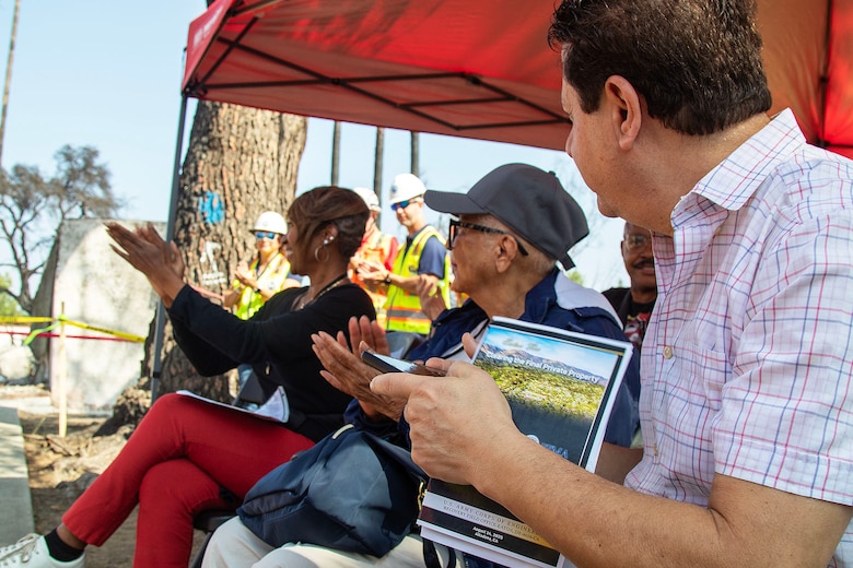Tami Outterbridge, far left, and her mother, Beverly, center, clap during a ceremony honoring the last private property debris removal by the U.S. Army Corps of Engineers in the Eaton Fire's impacted area Aug. 14 in Altadena, California. The Outterbridges' are the owners of the property.
