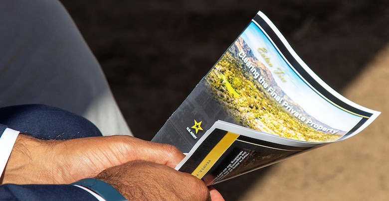 A guest holds a program for a ceremony honoring the beginning of the final private property debris removal in the Eaton Fire's impacted area Aug. 14 in Altadena, California.