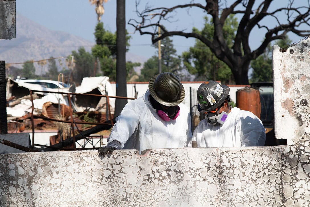 U.S. Army Corps of Engineers' contractors work on removing debris at the final private property assigned to USACE in the Eaton Fire's impact area Aug. 14 in Altadena, California.