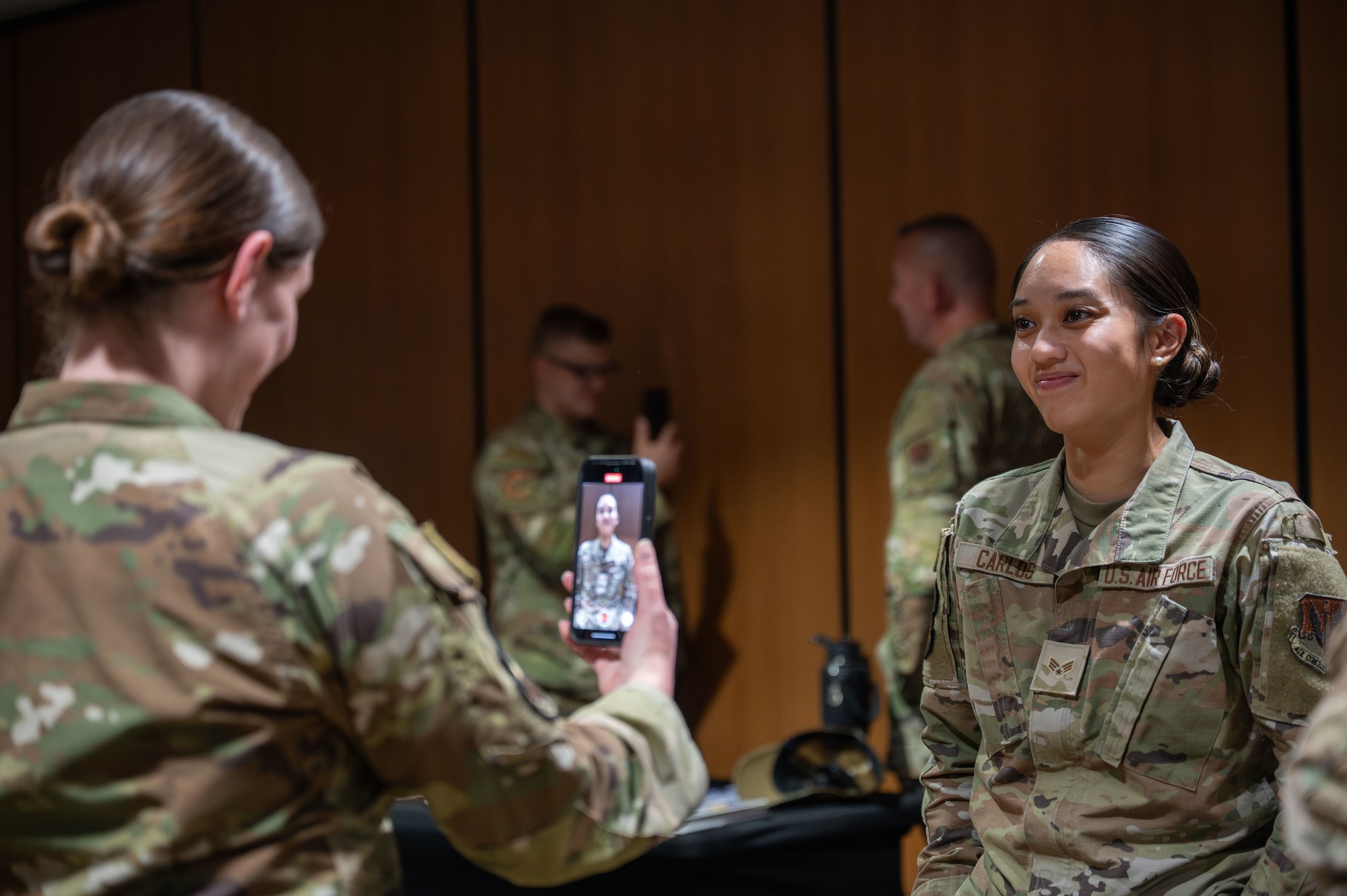 U.S. Air Force Staff Sgt. Rebecca Patterson, 355th Healthcare Operations Squadron noncommissioned officer in charge of hematology and urinalysis, records Senior Airman Kirsten Carlos, 355th Medical Group medical logistics technician, at Davis-Monthan Air Force Base, Arizona, Aug. 14, 2025. Airmen recorded videos addressing themselves about their vision and purpose for them to look back on whenever they need guidance. (U.S. Air Force photo by Senior Airman Jasmyne Bridgers-Matos)