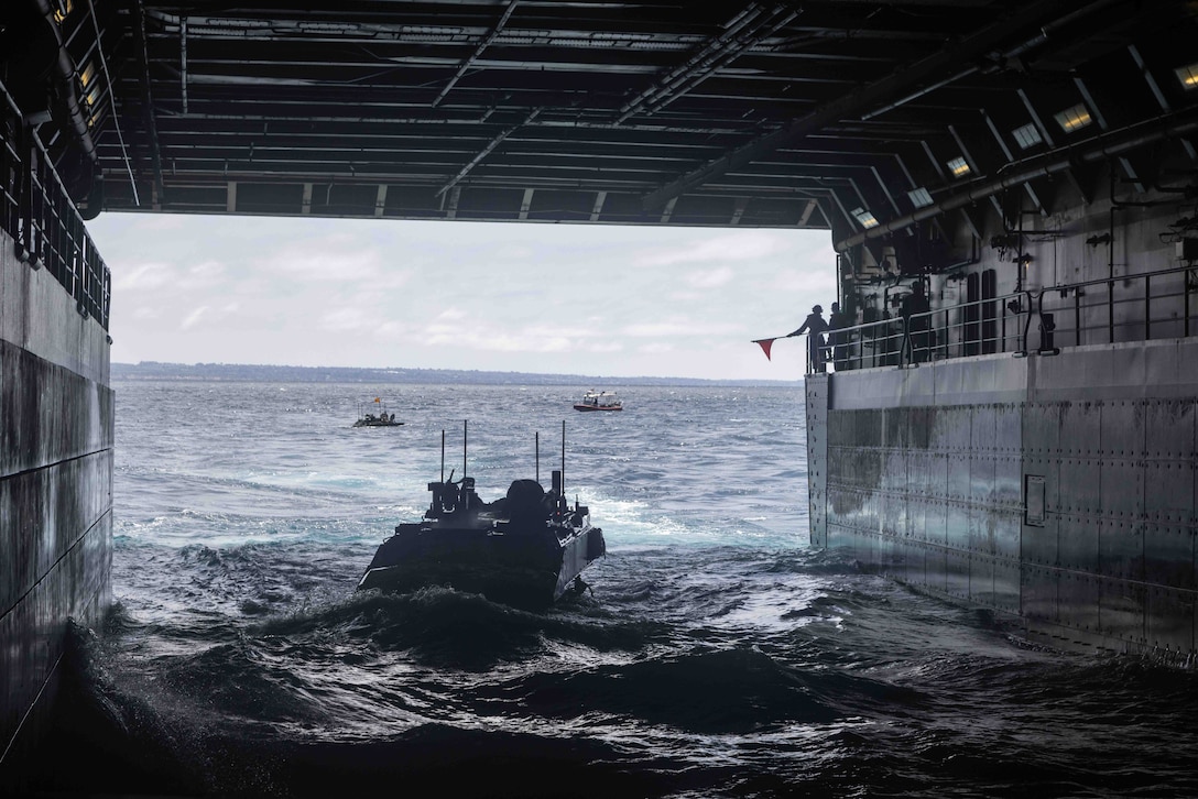 U.S. Marines with Charlie Company, 3rd Assault Amphibian Battalion, 1st Marine Division, disembark from the USS SOMERSET to conduct Amphibious Combat Vehicle Certifications off the coast at Marine Corps Base Camp Pendleton, California, as a part of Quarterly Amphibious Underway Readiness Training 25.4, Aug. 14, 2025. QUART is a joint training exercise, involving the integration of multiple units from I Marine Expeditionary Force and U.S. 3rd Fleet, designed to develop and sustain essential amphibious readiness skills for effective operations in maritime environments while reinforcing the Navy-Marine Corps partnership. (Marine Corps photo by Lance Cpl. Alan Gomez)