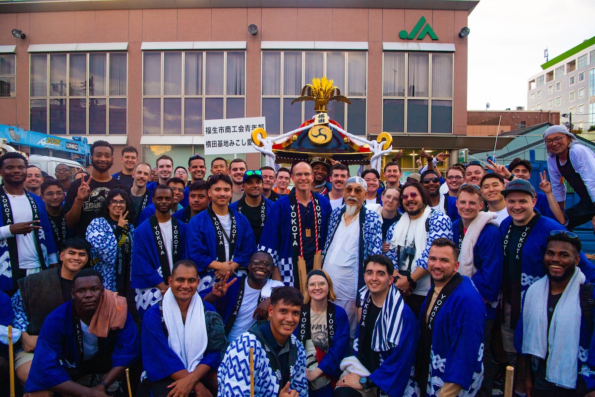 A group of people pose for a group photo.