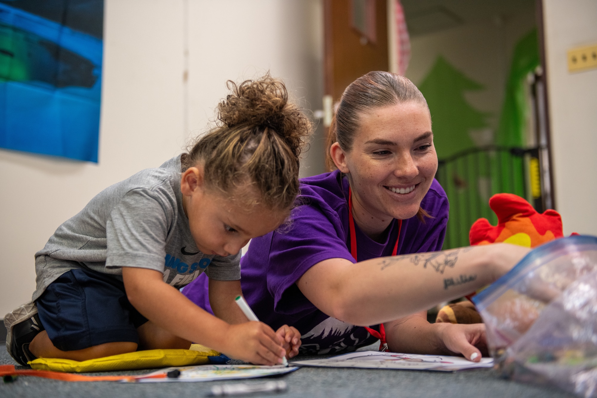 A student and volunteer engage in an arts and crafts activity during Vacation Bible School held by the Yokota Chapel at Yokota Air Base, Japan.