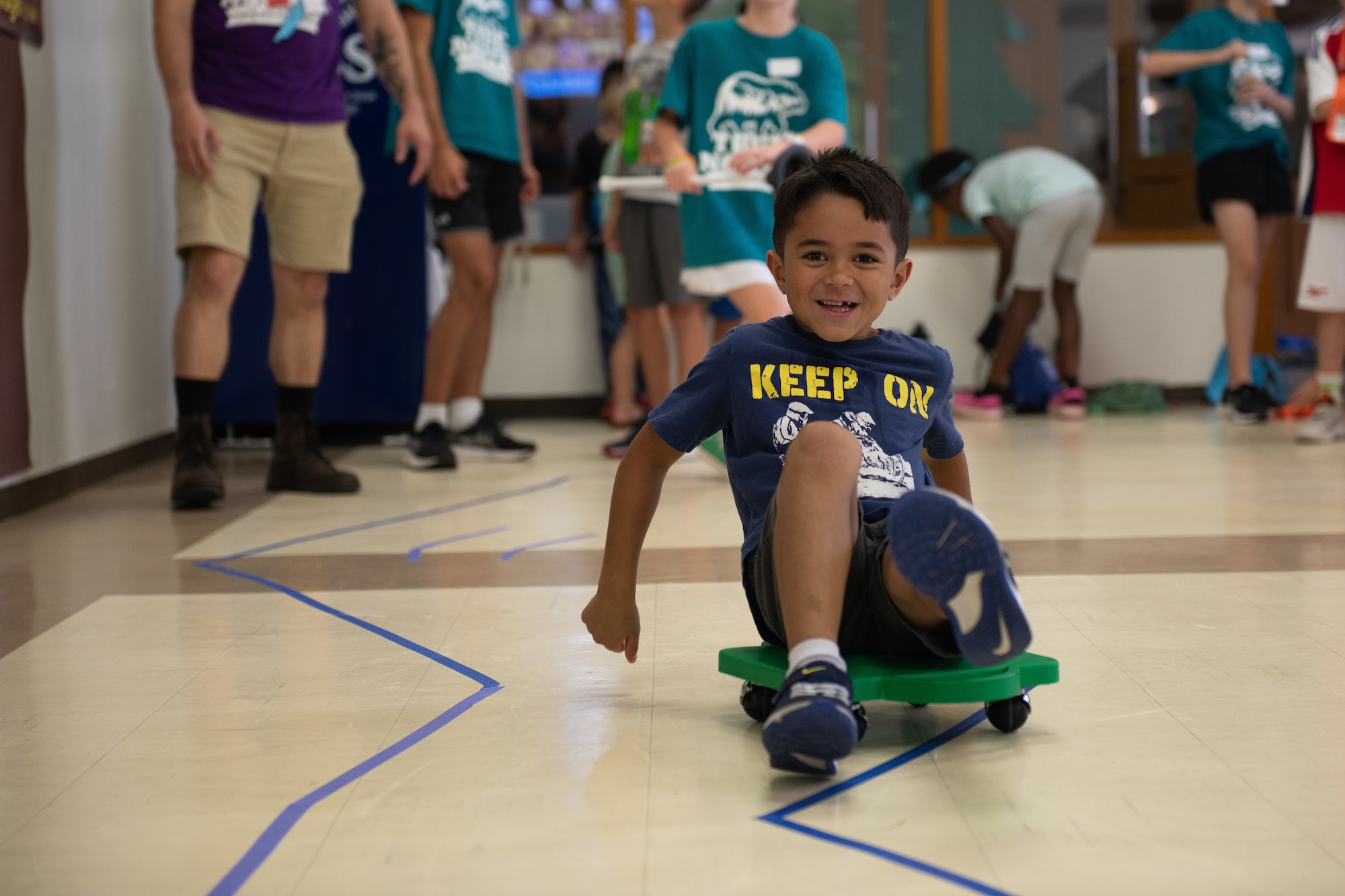 A student attending Vacation Bible School engages in a rolling activity at Yokota Air Base, Japan.