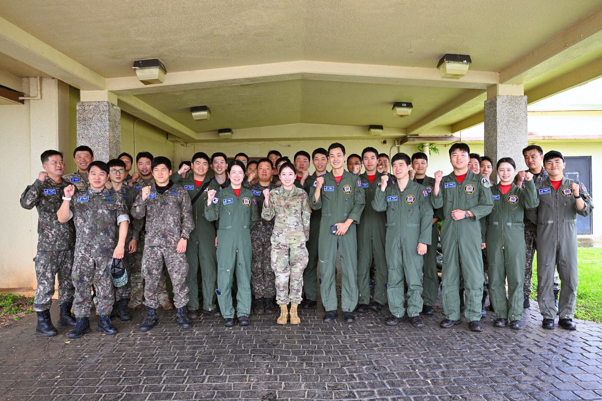 Republic of Korea Air Force members pose with U.S. Air Force 1st Lt. Esther Kim, Space Systems Command director of contracting and Language Enabled Airman Program participant, Los Angeles Air Force Base, California, during the U.S. Air Force’s 2025 Department-Level Exercise series at Andersen Air Force Base, Guam, July 28, 2025. LEAP empowers the DLE by enhancing linguistic and cultural interoperability, enabling more effective collaboration and mission success with partners and allies. DLE 2025 is a new way of conducting operations in a contested, dynamic environment to build capabilities, making a stronger, more deterrent force. The DLE encompasses all branches of the Department of Defense, along with Allies and partners, employing more than 400 Joint and coalition aircraft and more than 12,000 members at more than 50 locations across 3,000 miles. (Courtesy photo by ROKAF)