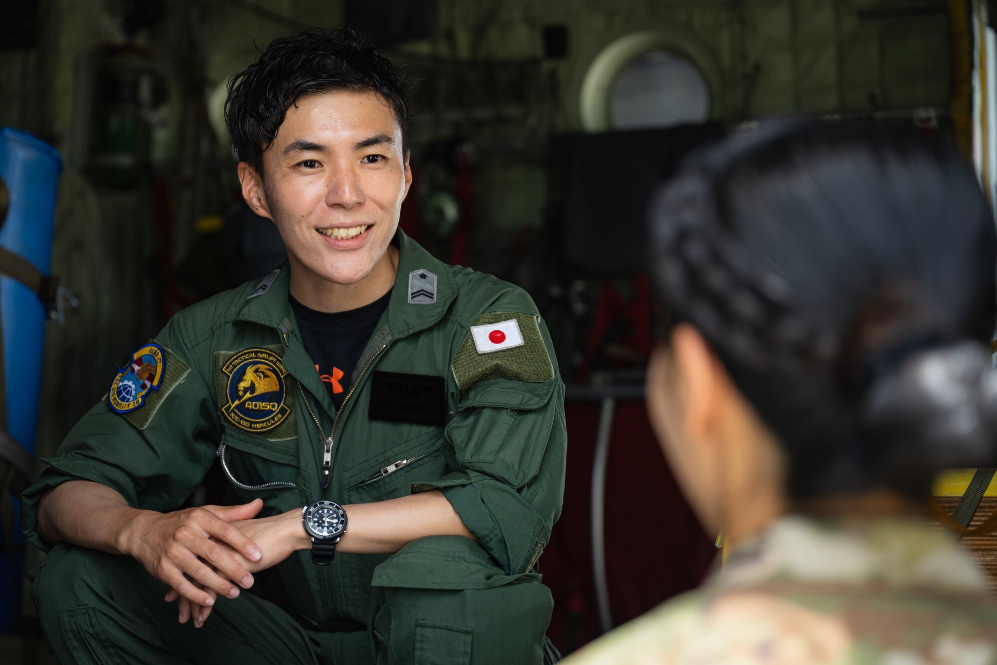 A Japan Air Self-Defense Force service member, left, talks with U.S. Air Force 2nd Lt. Julie Tatemoto, 51st Operations Support Squadron airfield operations director of operations and Language Enabled Airman Program participant, Osan Air Base, South Korea, during the U.S. Air Force’s 2025 Department-Level Exercise series at Andersen Air Force Base, Guam, July 22, 2025. LEAP empowers the DLE by enhancing linguistic and cultural interoperability, enabling more effective collaboration and mission success with partners and allies. DLE 2025 is a new way of conducting operations in a contested, dynamic environment to build capabilities, making a stronger, more lethal deterrent force. The DLE encompasses all branches of the Department of Defense, along with Allies and partners, employing more than 400 Joint and coalition aircraft and more than 12,000 members at more than 50 locations across 3,000 miles. (U.S. Air Force photo by Senior Airman Jade M. Caldwell)