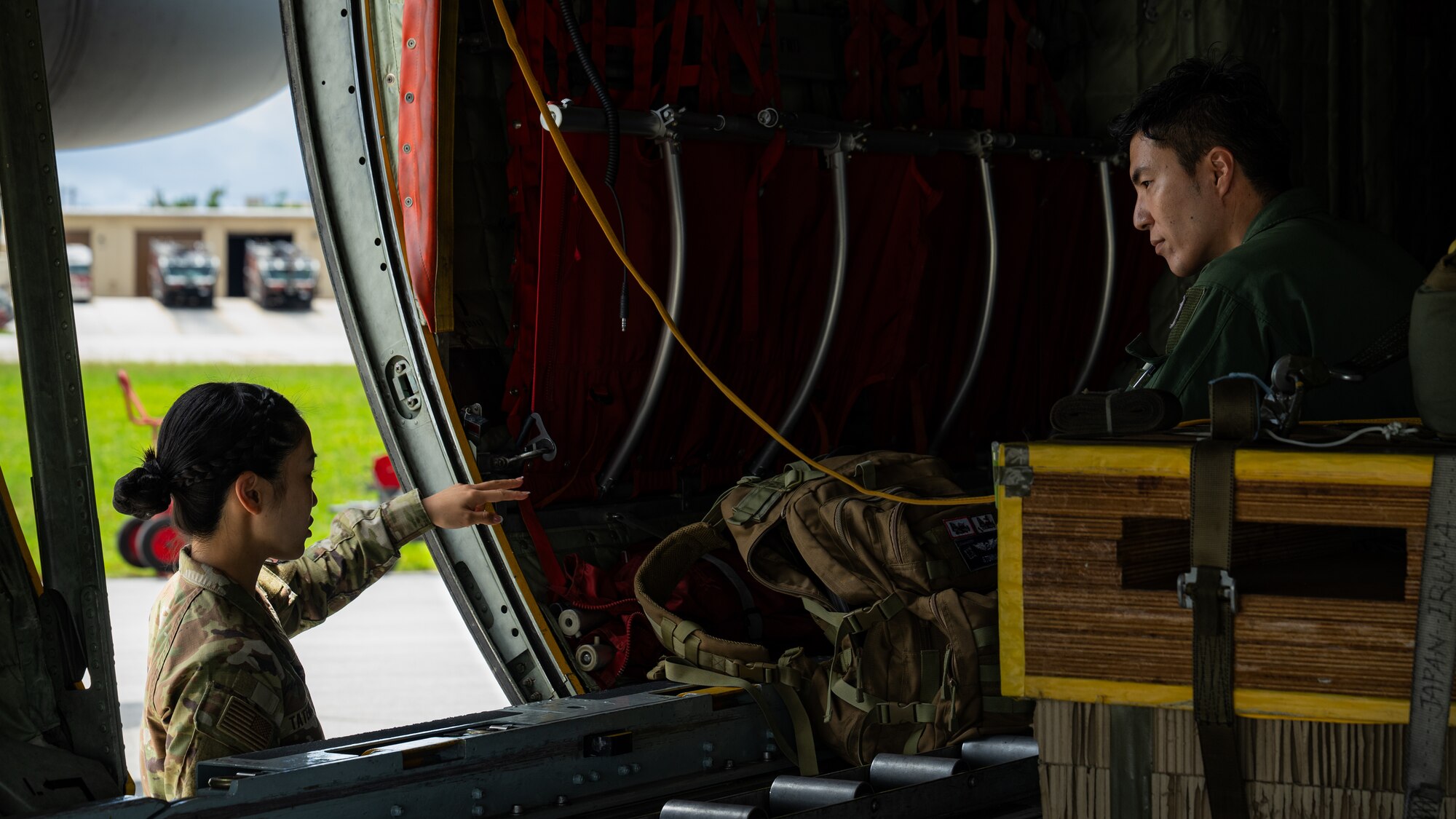 U.S. Air Force 2nd Lt. Julie Tatemoto, left, 51st Operations Support Squadron airfield operations director of operations and Language Enabled Airman Program participant, Osan Air Base, South Korea, talks with a member of the Japan Air Self-Defense Force during the U.S. Air Force’s 2025 Department-Level Exercise series at Andersen Air Force Base, Guam, July 22, 2025. LEAP empowers the DLE by enhancing linguistic and cultural interoperability, enabling more effective collaboration and mission success with partners and allies. DLE 2025 is a new way of conducting operations in a contested, dynamic environment to build capabilities, making a stronger, more deterrent force. The DLE encompasses all branches of the Department of Defense, along with Allies and partners, employing more than 400 Joint and coalition aircraft and more than 12,000 members at more than 50 locations across 3,000 miles. (U.S. Air Force photo by Senior Airman Jade M. Caldwell)