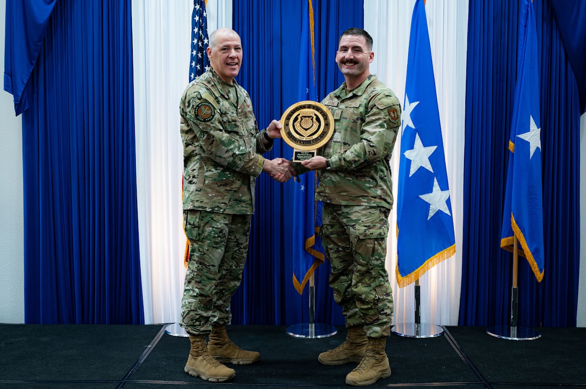 Airman at a ceremony posing for a photo.