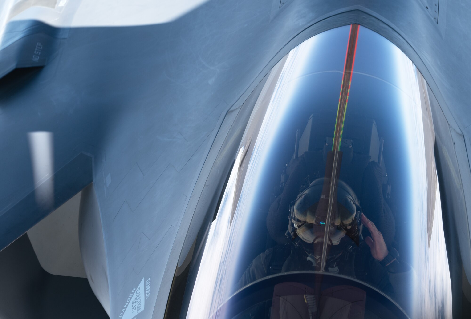 An F-35 Lightning II aircraft pilot assigned to the 176th Fighter Squadron, Wisconsin Air National Guard, salutes after receiving fuel from a KC-135 Stratotanker aircraft in the Indo-Pacific region, July 11, 2025. This total force integrated flight mission is part of the U.S. Air Force's 2025 Department-Level Exercise series, designed to strengthen and showcase its ability to operate at speed and scale, sustain prolonged operations, and rapidly shift across any theater. The DLE series encompasses all branches of the Department of Defense, along with Allies and partners, employing more than 400 joint and coalition aircraft and more than 12,000 personnel across more than 50 locations across 3,000 miles. (U.S. Air Force photo by Staff Sgt. Tryphena Mayhugh)