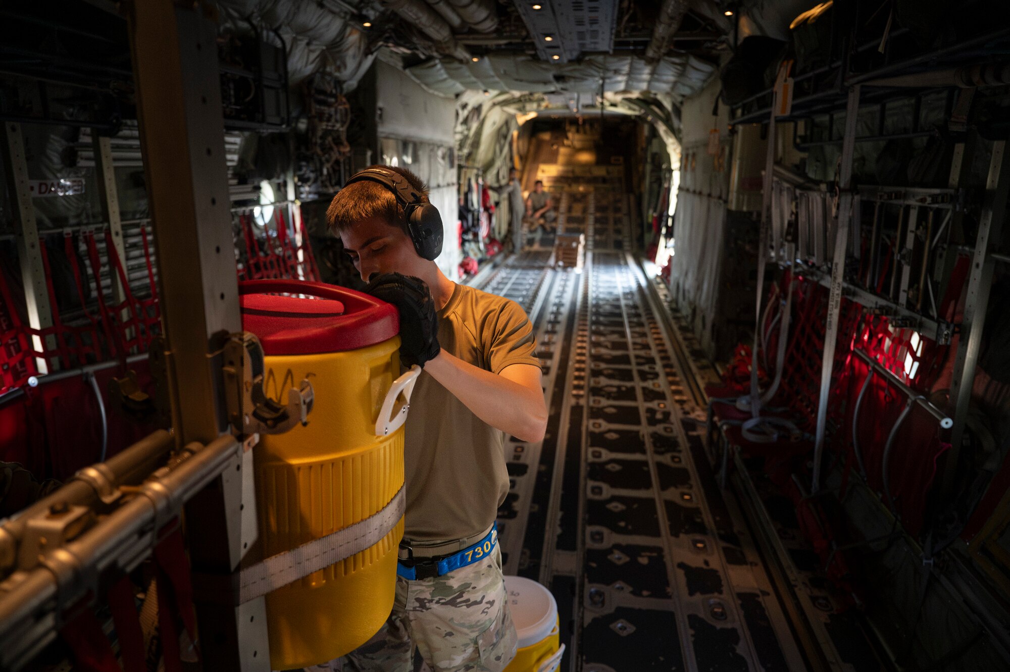 U.S. Air Force Senior Airman David Day, 730th Air Mobility Squadron passenger services representative, loads potable water into a C-130J Super Hercules aircraft for aircrew in support of Resolute Force Pacific 2025 at Yokota Air Base, Japan, July 25, 2025. The 730th AMS Fleet Services team ensures military and commercial aircraft are mission-ready by stocking essential supplies, removing waste, and servicing lavatories. REFORPAC is part of the first-in-a-generation Department-Level Exercise series, a new way of conducting operations in a contested, dynamic environment to build capabilities making a stronger, more deterrent force. The DLE encompasses all branches of the Department of Defense, Allies, and partners, employing over 400 joint and coalition aircraft and more than 12,000 personnel across more than 50 locations spanning 3,000 miles. (U.S. Air Force photo by Airman 1st Class Samantha Thorn)