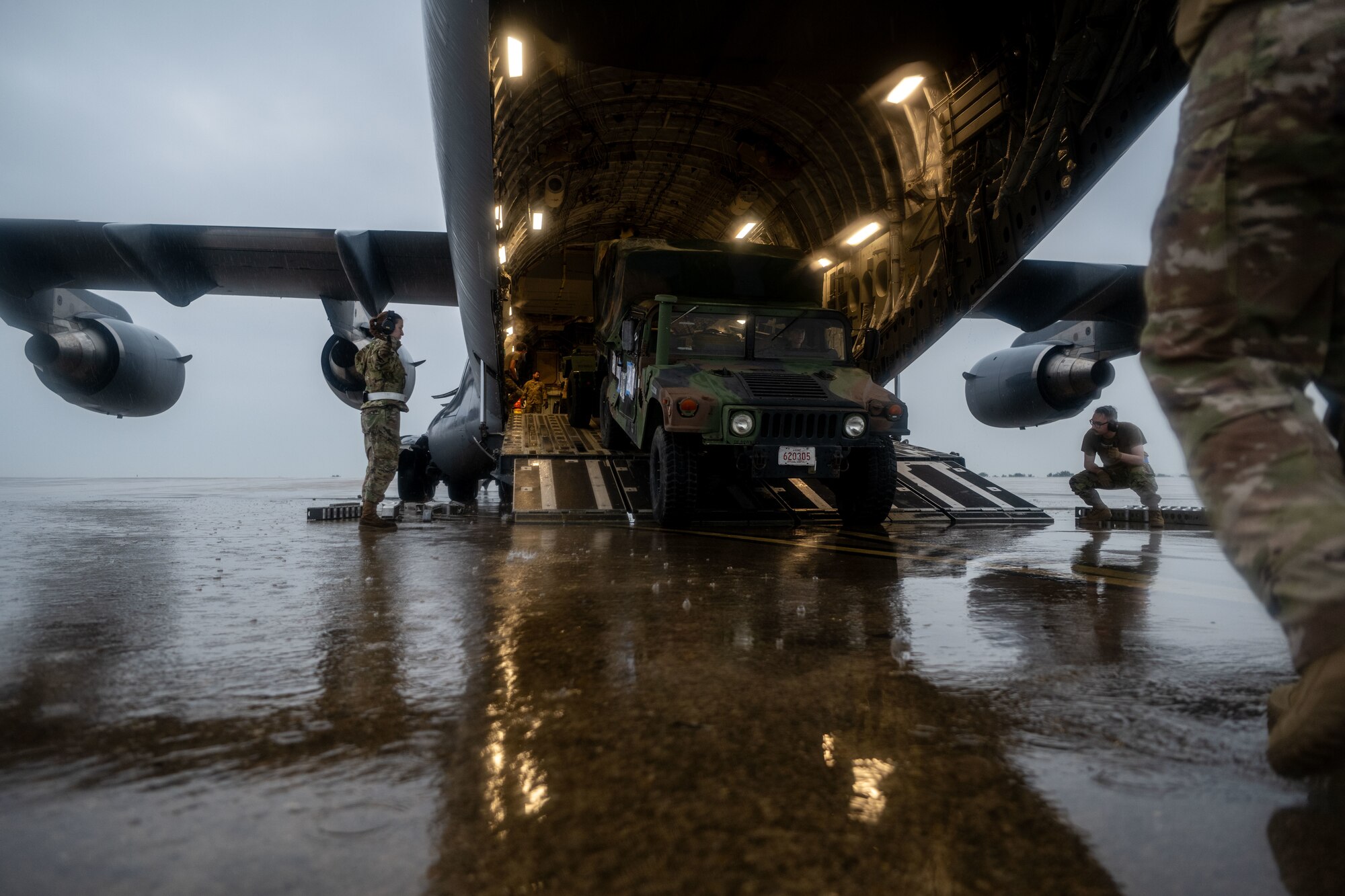 U.S. Air Force loadmasters assigned to the 21st Airlift Squadron, offload a Humvee at Kunsan Air Base, Republic of Korea, July 16, 2025. Air Mobility Command aircraft enable local, routine training and operations to deliver rapid global mobility, ensuring U.S. and Allied forces can project power and respond swiftly anywhere in the world. With a fleet of versatile aircraft, AMC provides the critical capability to transport personnel, equipment, and supplies when and where needed. (U.S. Air Force photo by Senior Airman Zachary Foster)
