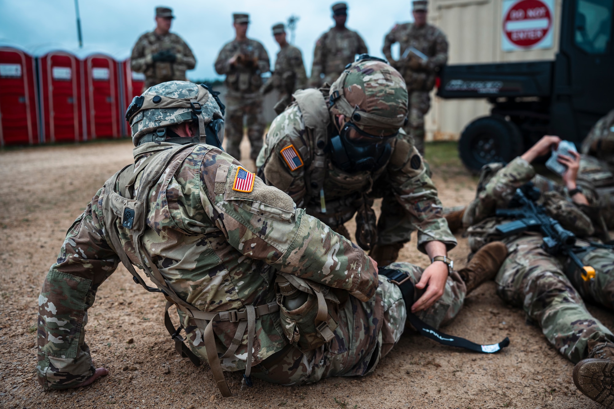 A medic applies a tourniquet to a patient during a simulated CBRNE event