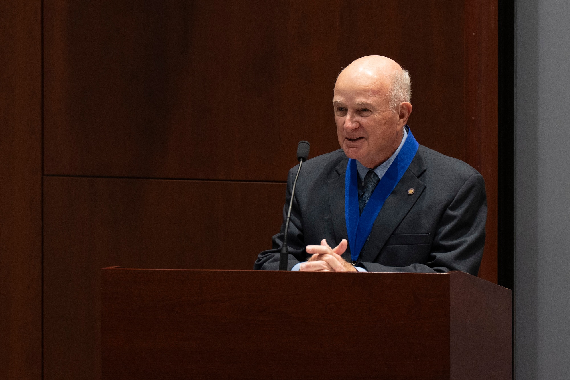 Retired Air Force Maj. Louis W. Seiler Jr., addresses the audience at his induction to the Air Force Technical Applications Center’s Wall of Honor ceremony July 15, 2025 at Patrick Space Force Base, Fla.  Seiler was chosen for induction based on his vast and impactful contributions to the nuclear treaty monitoring center’s global mission during his time on active duty. (U.S. Air Force photo by Matthew S. Jurgens)