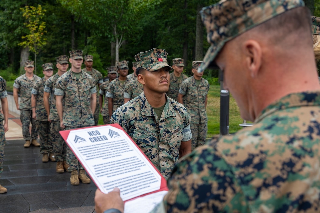 U.S. Marine Corps 1st Sgt. Joel Burns, the first sergeant of Alpha Company, Combat Logistics Battalion 22, Combat Logistics Regiment 27, and a native of California, reads the promotion warrant for Cpl. Christian Martinez Vazquez, a logistics specialist with CLB-22, CLR-27, during a promotion ceremony at the Marine Corps Museum, Virginia, Aug. 1, 2025. The logistics combat element of the Special Purpose Marine Air-Ground Task Force – Alert Contingency MAGTF (SPMAGTF-ACM), CLB-22, conducted a DFT to increase proficiency in comprehensive combat service support and improve overall combat readiness for any potential MAGTF missions. (U.S. Marine Corps photo by Lance Cpl. Jack Labrador)