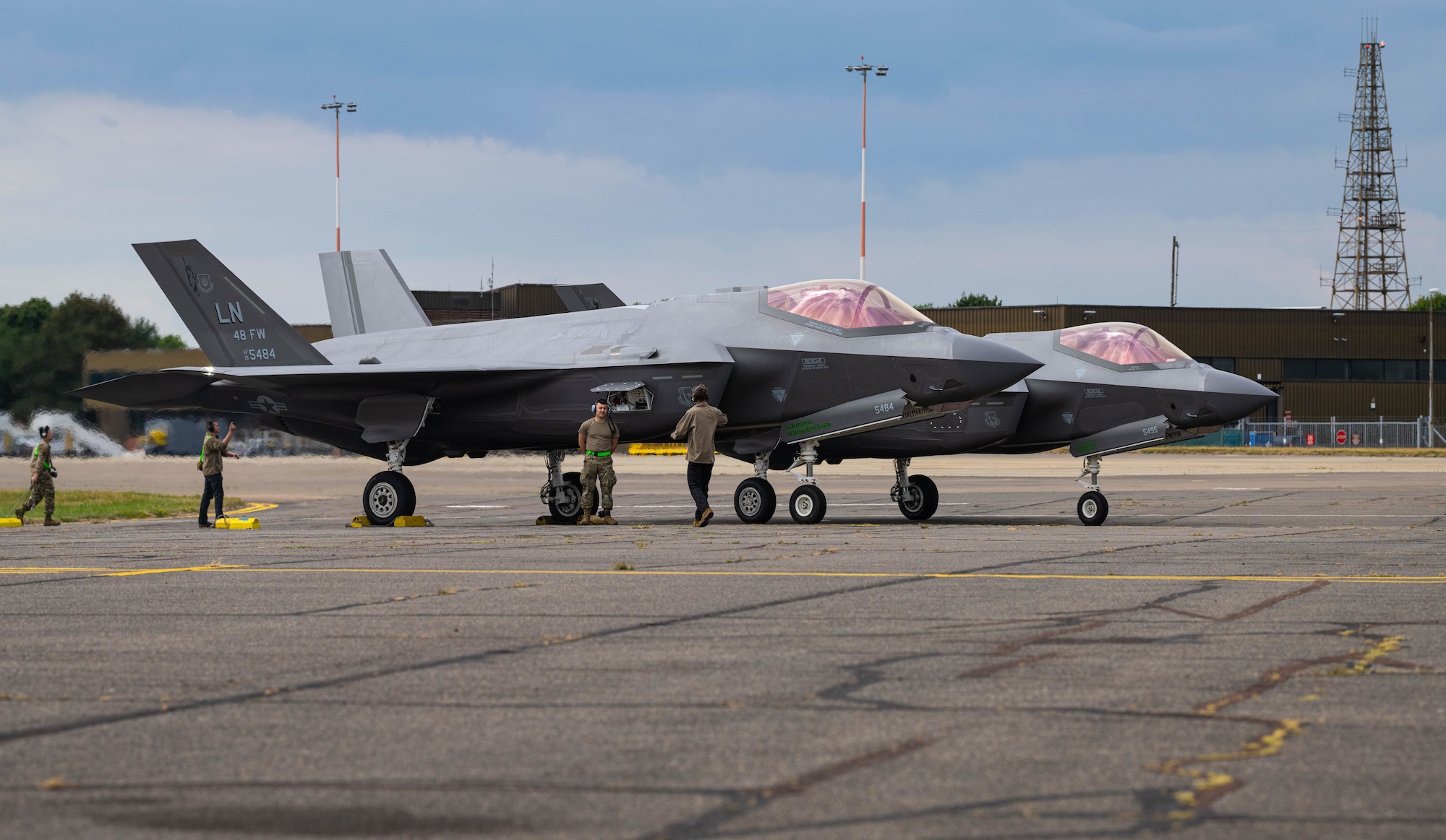Two U.S. Air Force F-35A Lightning II’s assigned to the 48th Fighter Wing rest on a runway at RAF Mildenhall, England, July 16, 2025.