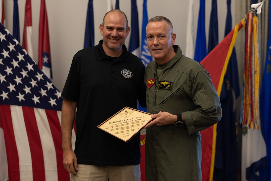 William Lewis Jr., left, the mayor of Havelock, North Carolina, and U.S. Marine Corps Maj. Gen. William Swan, from Wisconsin, commanding general, 2nd Marine Aircraft Wing (MAW) pose for a photo at Marine Corps Air Station (MCAS) Cherry Point, North Carolina, Aug. 14, 2025. Lewis was made an honorary member of 2nd MAW to celebrate the strong and enduring relationships between 2nd MAW, MCAS Cherry Point, and the City of Havelock. (U.S. Marine Corps photo by Lance Cpl. Orlanys Diaz Figueroa)